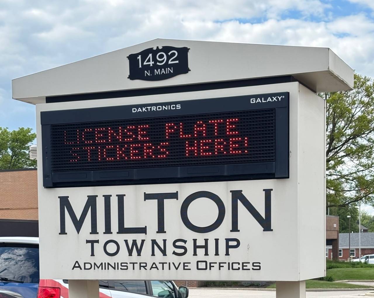 Stickers Here Milton Township Marquee Sign that reads plate stickers here